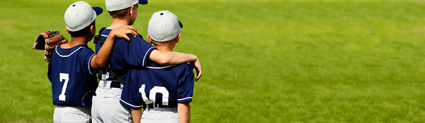 Young baseball players grouped together after a game waiting for healthy post-game snacks