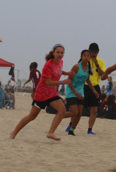 Supplements: Young girls playing sand soccer at the beach