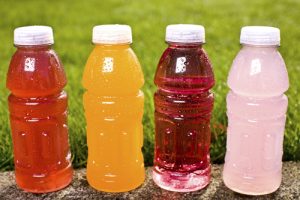 sports nutrition: four multi-colored sports drink bottles just waiting to be gulped